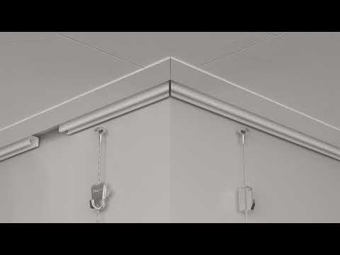 STAS u-rail picture hanging system easily attaches to wooden ceiling tiles, perfect for schools.